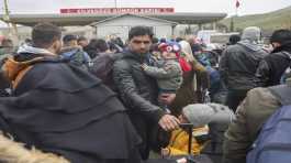 Syrians wait to cross into Syria from Turkey at the Cilvegozu border gate