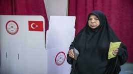 woman votes at a polling station