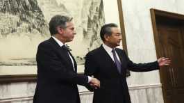 Antony Blinken shakes hands with Wang Yi