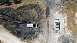 burned vehicles after an attack by Israeli settlers