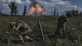 Ukrainian soldiers fire a mortar