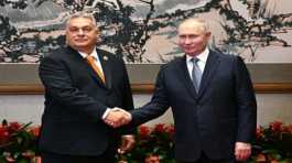 Vladimir Putin shakes hands with Viktor Orban