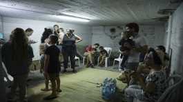 israelis take cover in a shelter