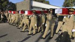 officers carry the coffins