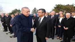 Tayyip Erdogan shakes hands with Ozgur Ozel