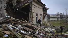 Ukrainian sapper inspects a destroyed building