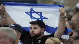 man hold up Israeli flag