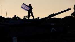 Israeli soldier holds up an Israeli flag